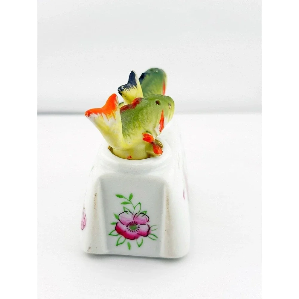 Vintage Japanese porcelain nodder fish salt & pepper shakers with a floral base